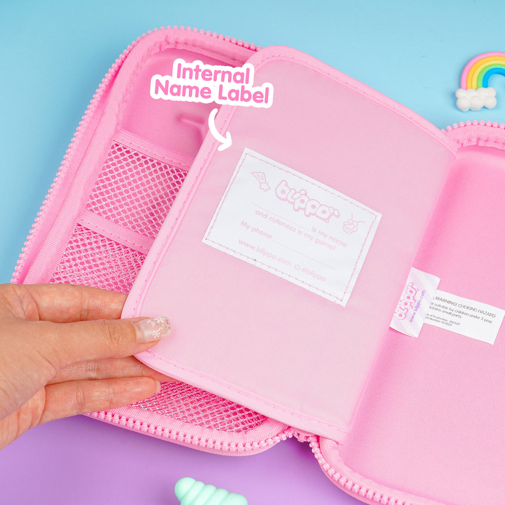 Woman opening a pink kawaii pencil case for girls with a cute name label.